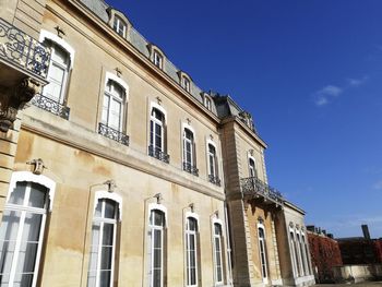 Low angle view of building against blue sky