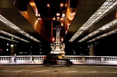 Blurred motion of illuminated bridge at night