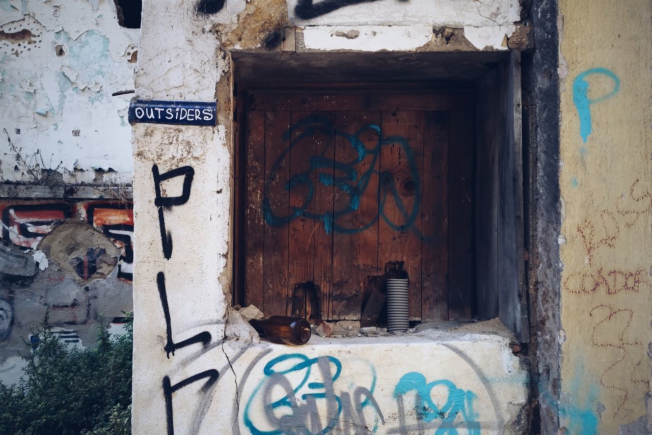 text, communication, western script, built structure, architecture, wall - building feature, old, building exterior, weathered, door, graffiti, abandoned, deterioration, close-up, run-down, damaged, capital letter, obsolete, non-western script, number