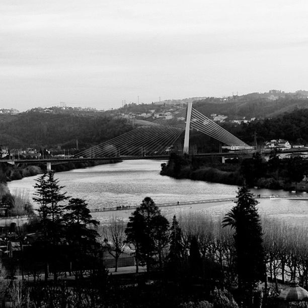 built structure, architecture, connection, bridge - man made structure, building exterior, tree, river, mountain, transportation, sky, bridge, water, landscape, engineering, clear sky, house, outdoors, nature, mountain range, no people