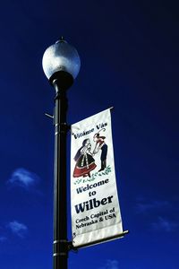 Low angle view of communications tower against blue sky