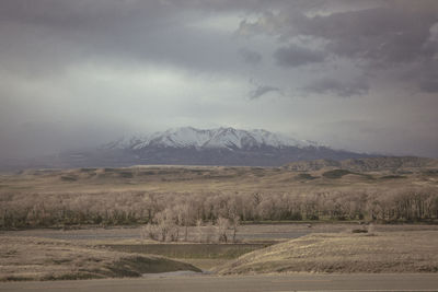 Scenic view of mountains against cloudy sky