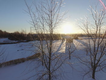 Scenic view of lake against sky during winter