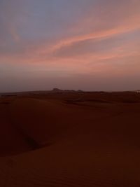 Scenic view of desert against sky during sunset