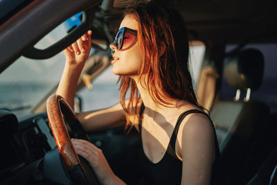 Midsection of woman sitting in car