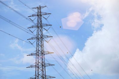 Low angle view of electricity pylon against sky