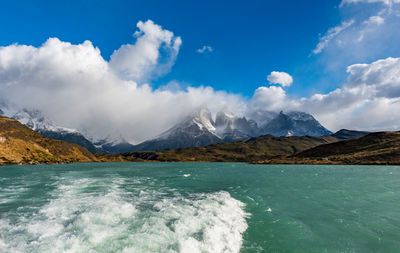 Scenic view of sea and mountains against sky