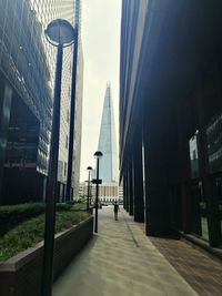 Street amidst buildings against sky in city