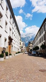 Street amidst buildings against sky