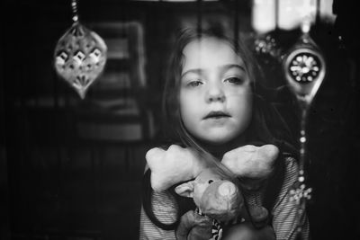 Portrait of cute girl holding mask