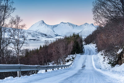 Snow covered landscape against clear sky