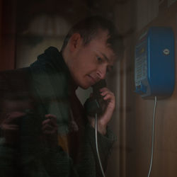 Young man talking on telephone