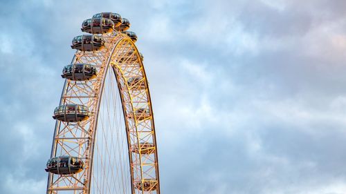 Low angle view of ferris wheel against sky