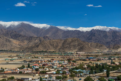 Aerial view of buildings against mountain range
