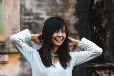 Portrait of smiling young woman standing outdoors