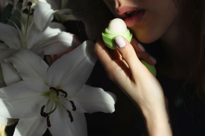 Close-up of woman applying lip balm