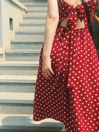 Midsection of woman standing on staircase