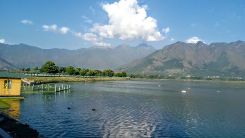 Scenic view of lake and mountains against sky