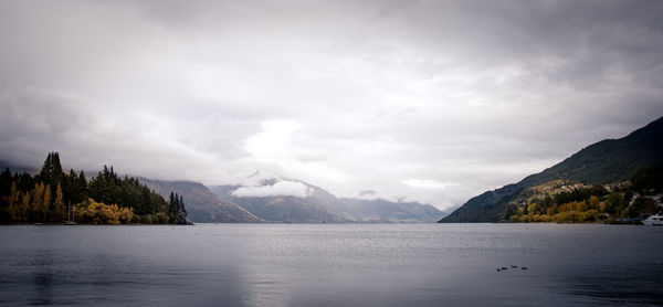 Scenic view of lake and mountains against sky