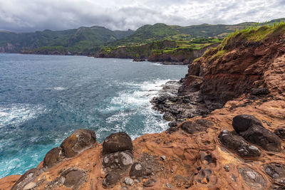 Scenic view of sea and mountains against sky