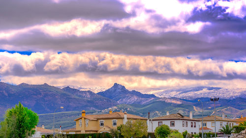 Houses and mountains against sky
