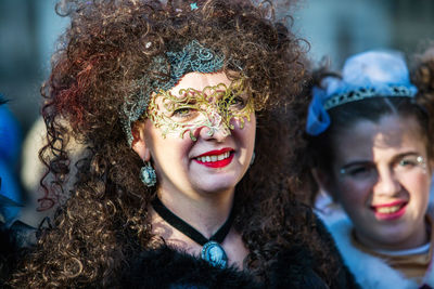 Portrait of smiling women wearing costume and mask during venice carnival