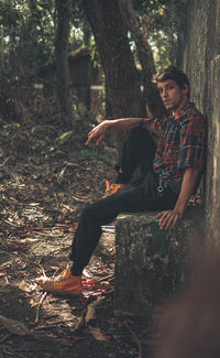 Young man looking at camera in forest
