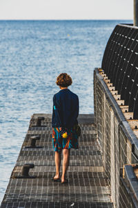 Rear view of man looking at sea