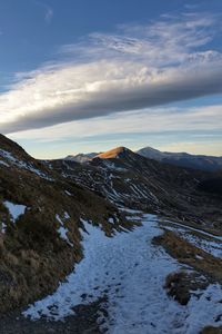 Scenic view of snowcapped mountains against sky during sunset