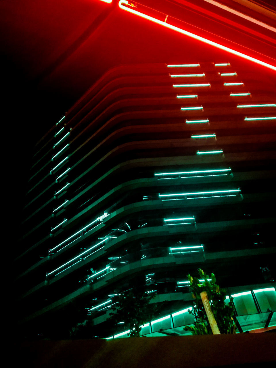 LOW ANGLE VIEW OF ILLUMINATED LIGHTS IN BUILDING AT NIGHT