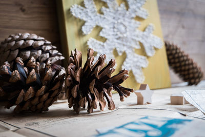 Close-up of pine cones and christmas decorations on table