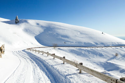 Winter landscape, curves road with snow. mount grappa landscape, italy