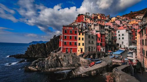 Panoramic view of sea and buildings against sky