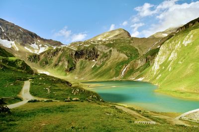 Scenic view of lake and mountains against sky