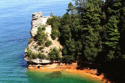 High angle view of cliff by sea against sky
