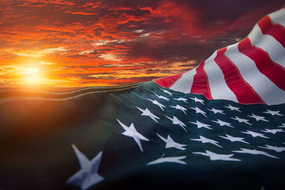 Close-up of flag against sky during sunset