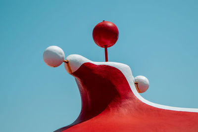 Low angle view of balloons against blue sky