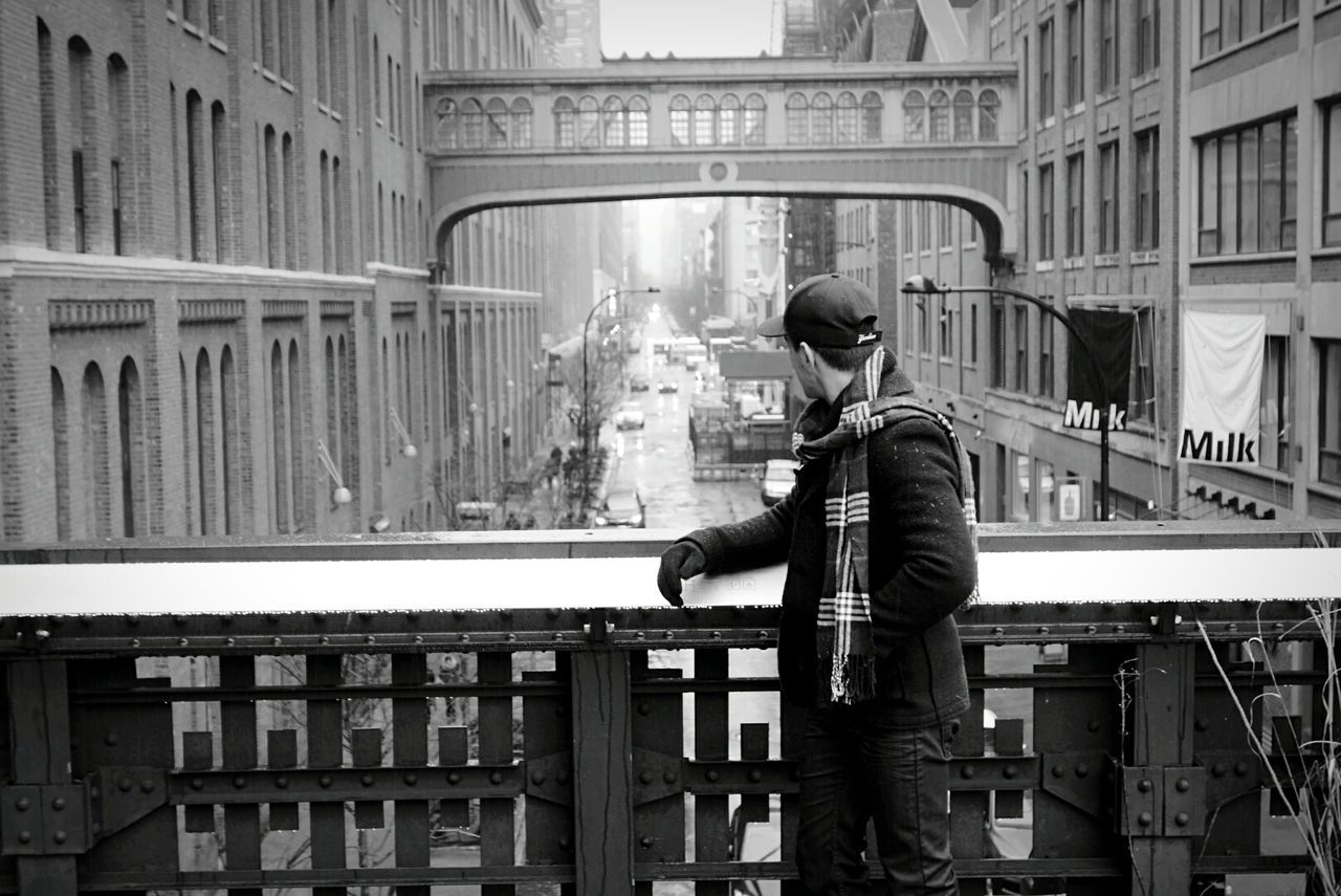 architecture, built structure, building exterior, lifestyles, leisure activity, full length, railing, men, city, rear view, casual clothing, building, standing, city life, person, walking, three quarter length