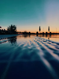 Swimming pool against sky at sunset