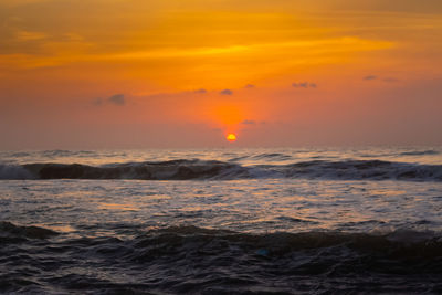 Scenic view of sea against orange sky