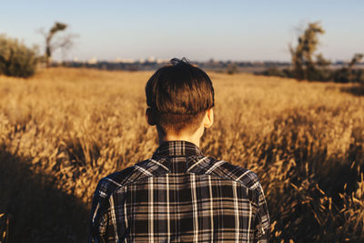 Rear view of a person standing on field