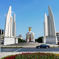 Low angle view of democracy monument against blue sky on sunny day