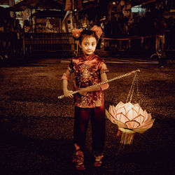 Portrait of girl standing on landscape at night