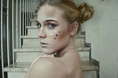 Portrait of young woman with glitter make-up