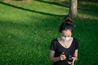 Series photo of young women with camera in public park outdoor on sunny day