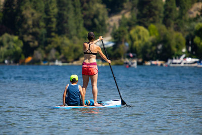 Rear view of man on boat in water