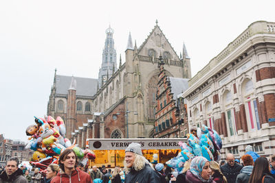 People at temple against sky in city