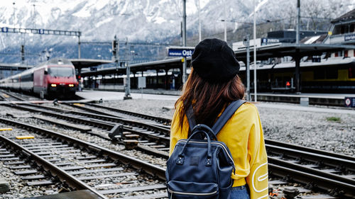 Rear view of woman on train at railroad station