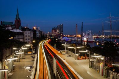 Light trails on city road by river