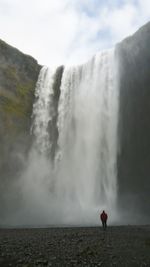 Scenic view of waterfall against sky